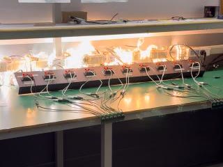 Multiple connected light products illuminated together on a factory test bench