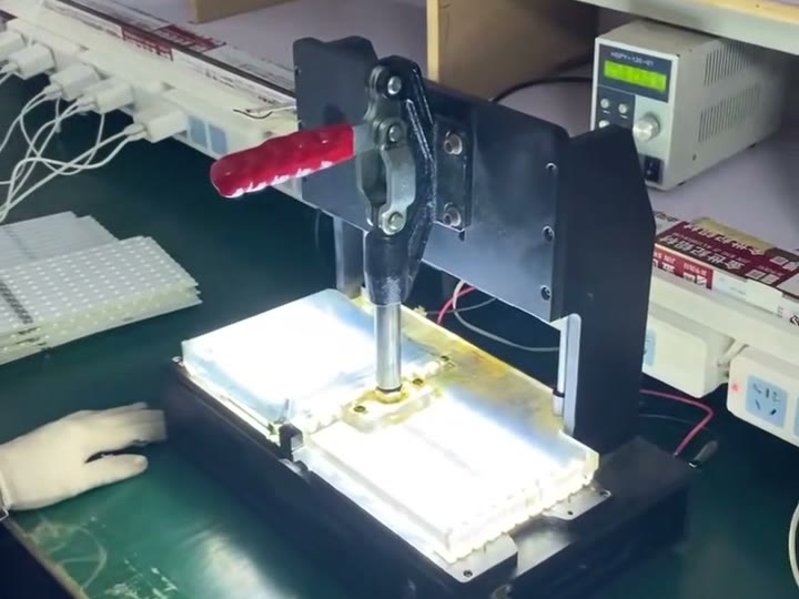 Factory-supplied functional-check station used to verify an illuminated product