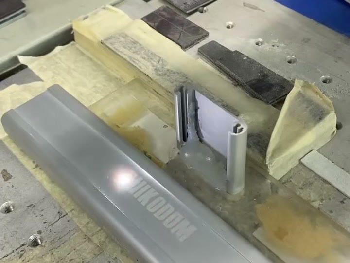 Laser marking a TUODI logo on an aluminium sensor-light housing