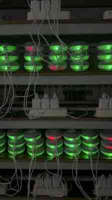 Multi-tier factory rack with connected units showing green indicators