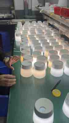 Multiple round light units illuminated together on a factory bench