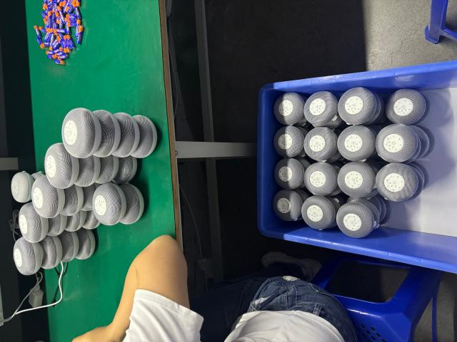 Round light units arranged in blue work-in-process bins