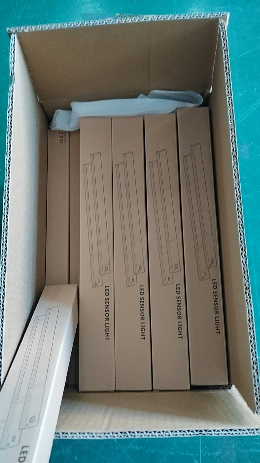 Neutral kraft LED sensor-light boxes packed inside a master carton