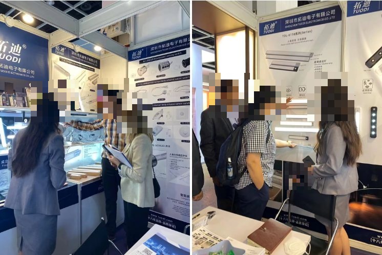 Visitors viewing TUODI sensor lighting on the exhibition stand